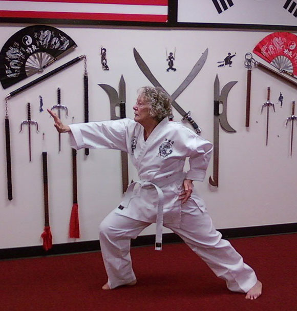 Woman with a white belt doing Tai Chi